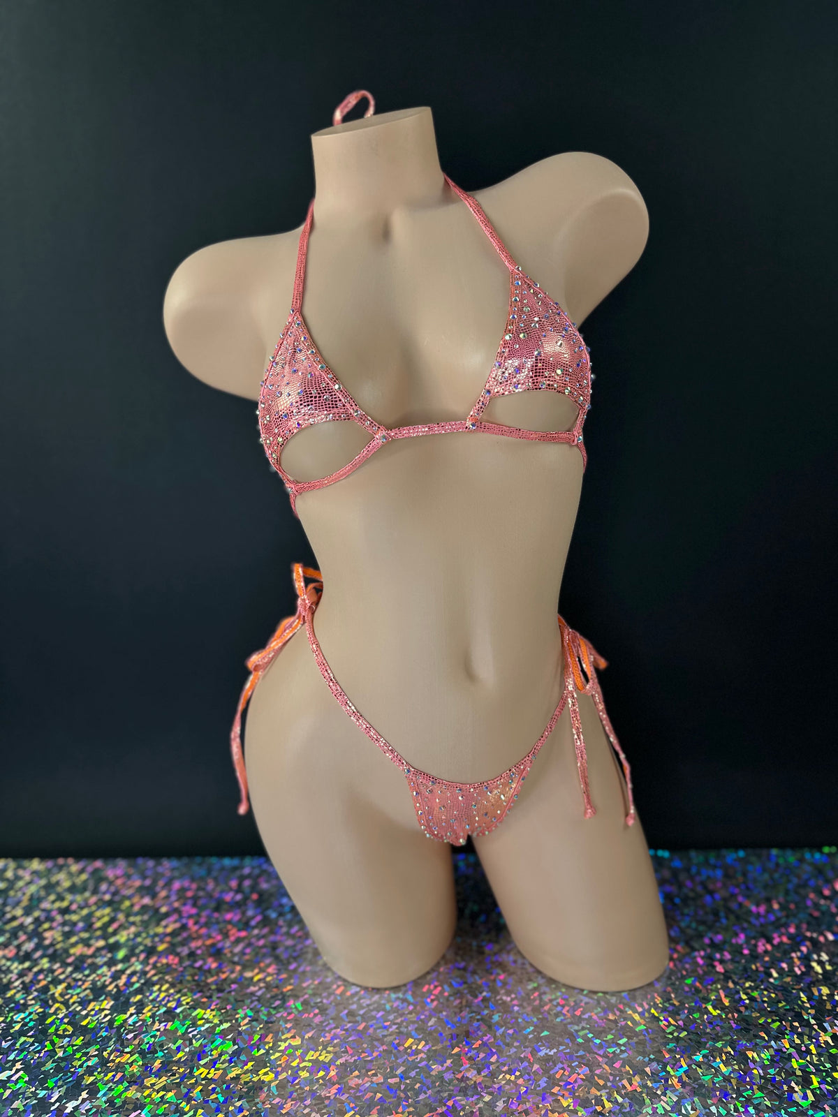 Citrus orange Aja rhinestone cutout 'kini, front view on dark background with holographic floor - Golddiggers Boutique