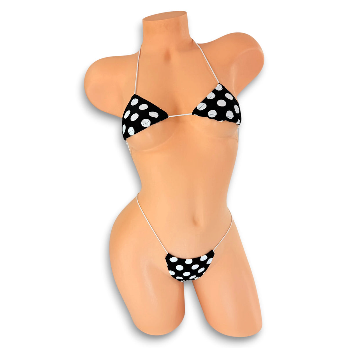 Front view of Black and White Polka Dot micro 'kini on mannequin, retro pin-up exotic dancewear on white strings