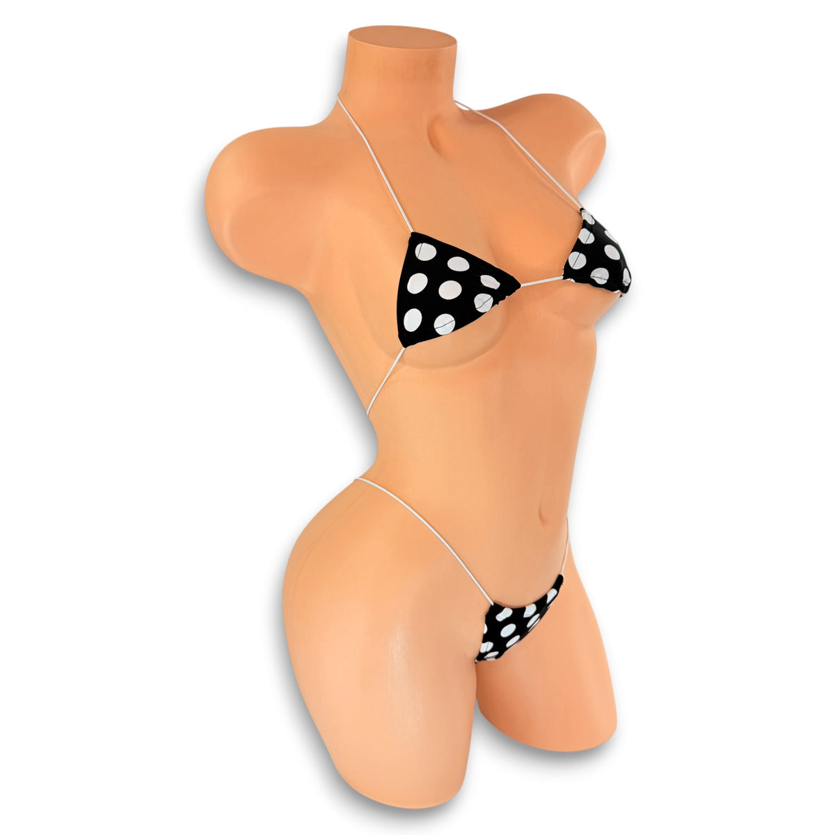 Side view of Black and White Polka Dot micro 'kini on mannequin, black with large white dots