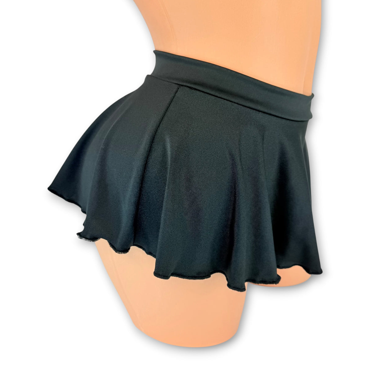 Black flare mini skirt side view showing the wide waistband and skater cut