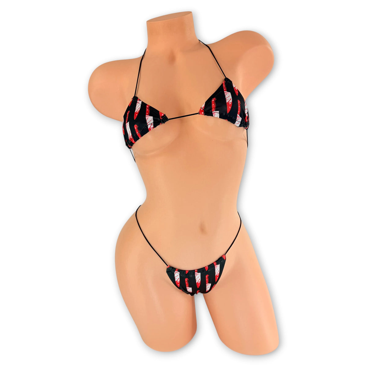 Front view of Bloody Knives micro 'kini on mannequin, black bloody knife print triangle top and g-string on black strings