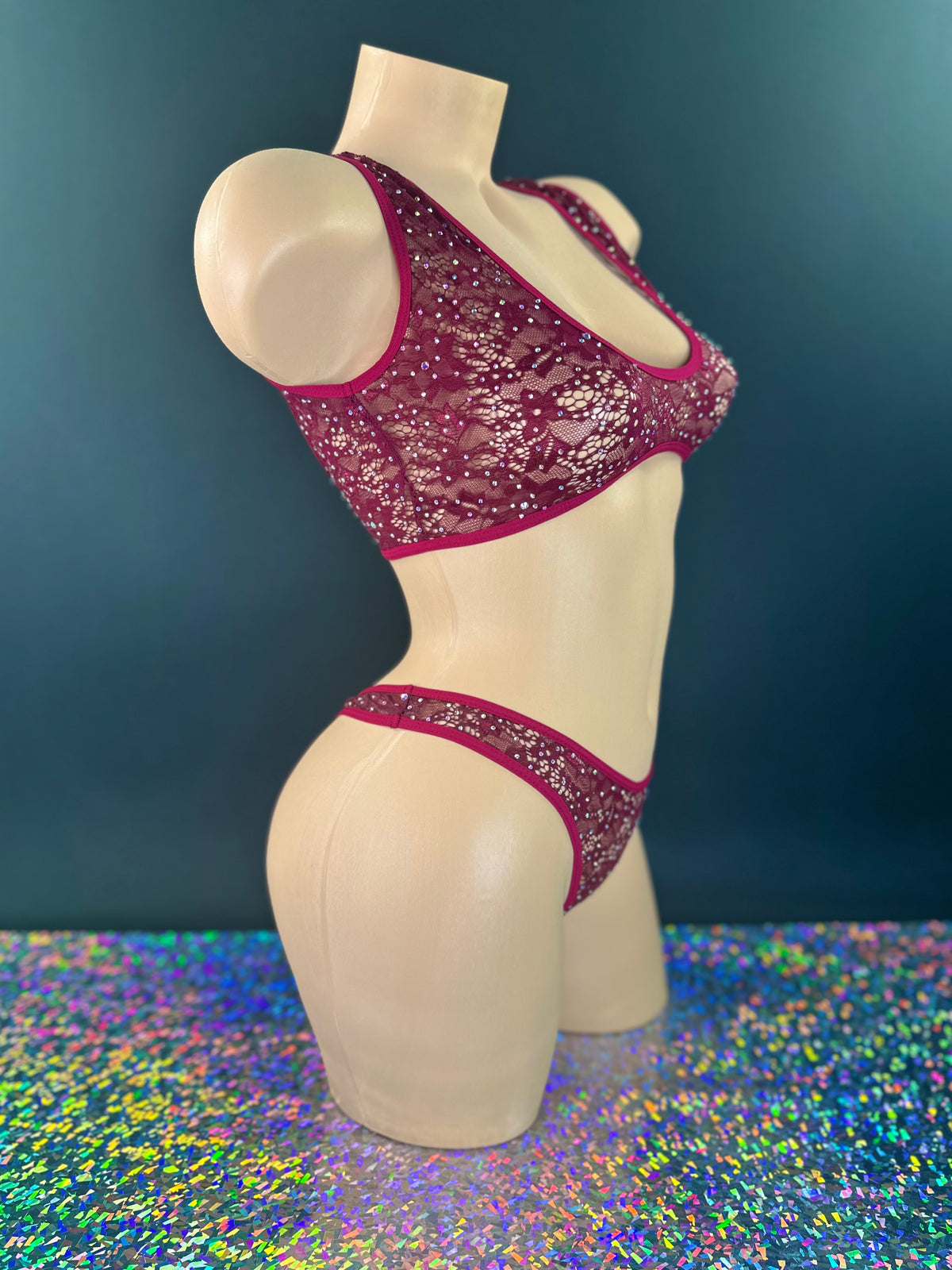 Caroline burgundy lace set, side view on dark background with holographic floor - Golddiggers Boutique