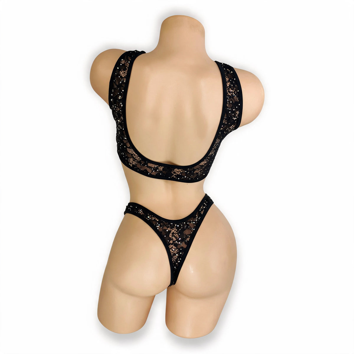 Back view of Caroline black lace set on mannequin showing wide scoop back and rhinestone lace thong back