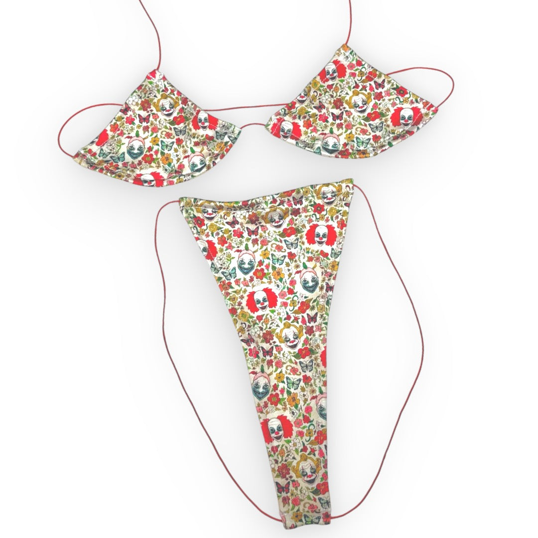 Killer Clown micro 'kini, flat lay of triangle top and g-string thong on red strings, Golddiggers Boutique