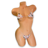 Cream cowgirl print micro 'kini with pink hats and pink and brown boots on mannequin, front view - Golddiggers Boutique