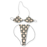 Cream and black checkerboard daisy micro 'kini on black strings, flat lay on white - Golddiggers Boutique