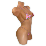 Pink birthday cupcake print micro 'kini with lilac strings on mannequin, angled side view - Golddiggers Boutique