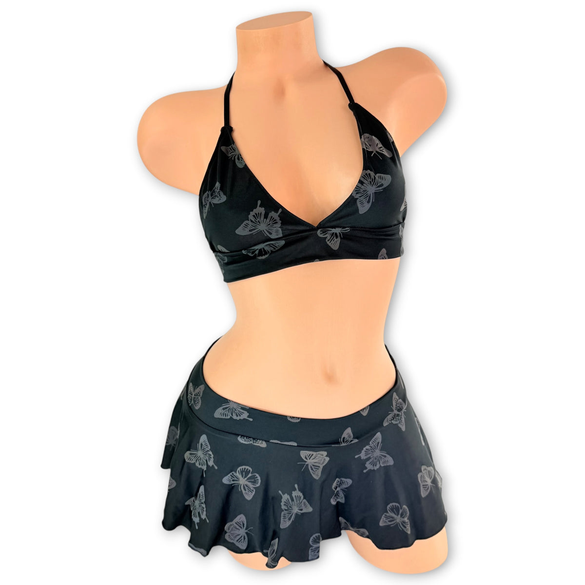 Black Mariposa halter top and flared mini skirt in regular light, subtle butterfly print, front view - Golddiggers Boutique