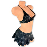 Black Mariposa halter top and flared mini skirt in regular light, side view - Golddiggers Boutique