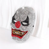 Silver rhinestone clown mask with red nose and gold crystal teeth, angled view - Golddiggers Boutique
