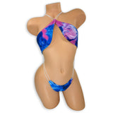 Smoked Eva pink, blue, and purple smoke print slingshot bodysuit on mannequin, front view - Golddiggers Boutique