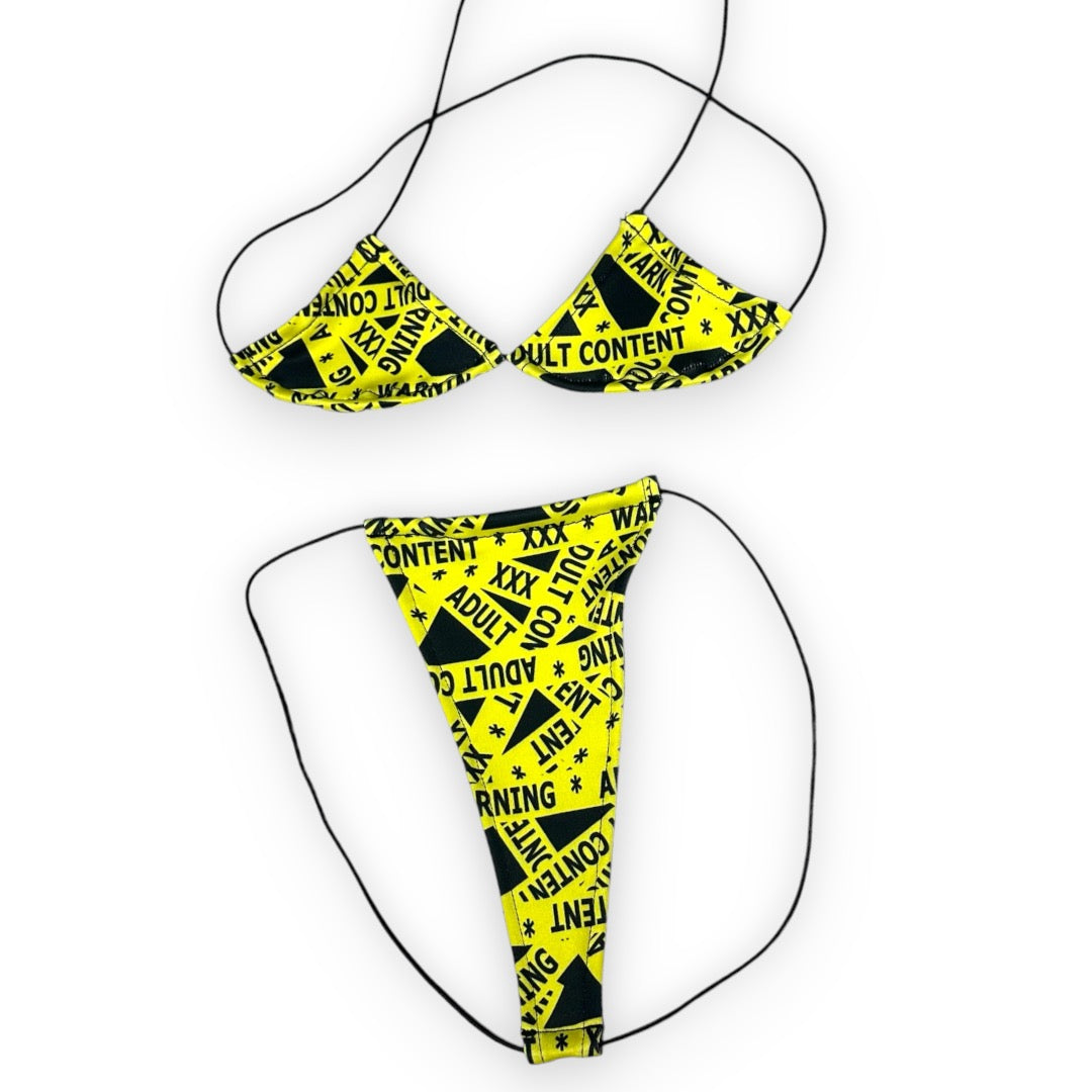 Caution Tape micro 'kini, flat lay of triangle top and g-string thong on black strings, Golddiggers Boutique