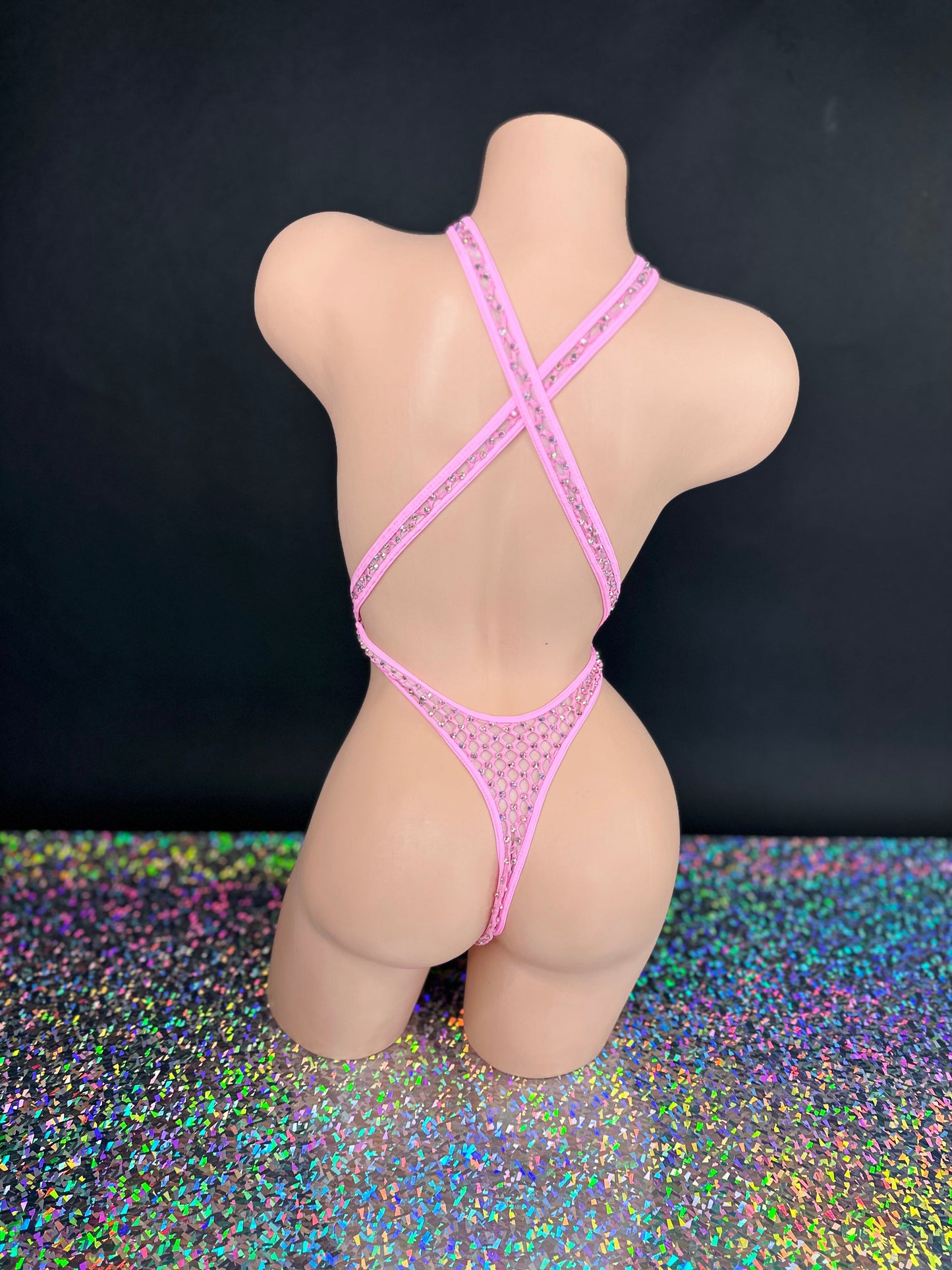 Bubble gum pink Ann criss-cross bodysuit, angled front view on dark background - Golddiggers Boutique