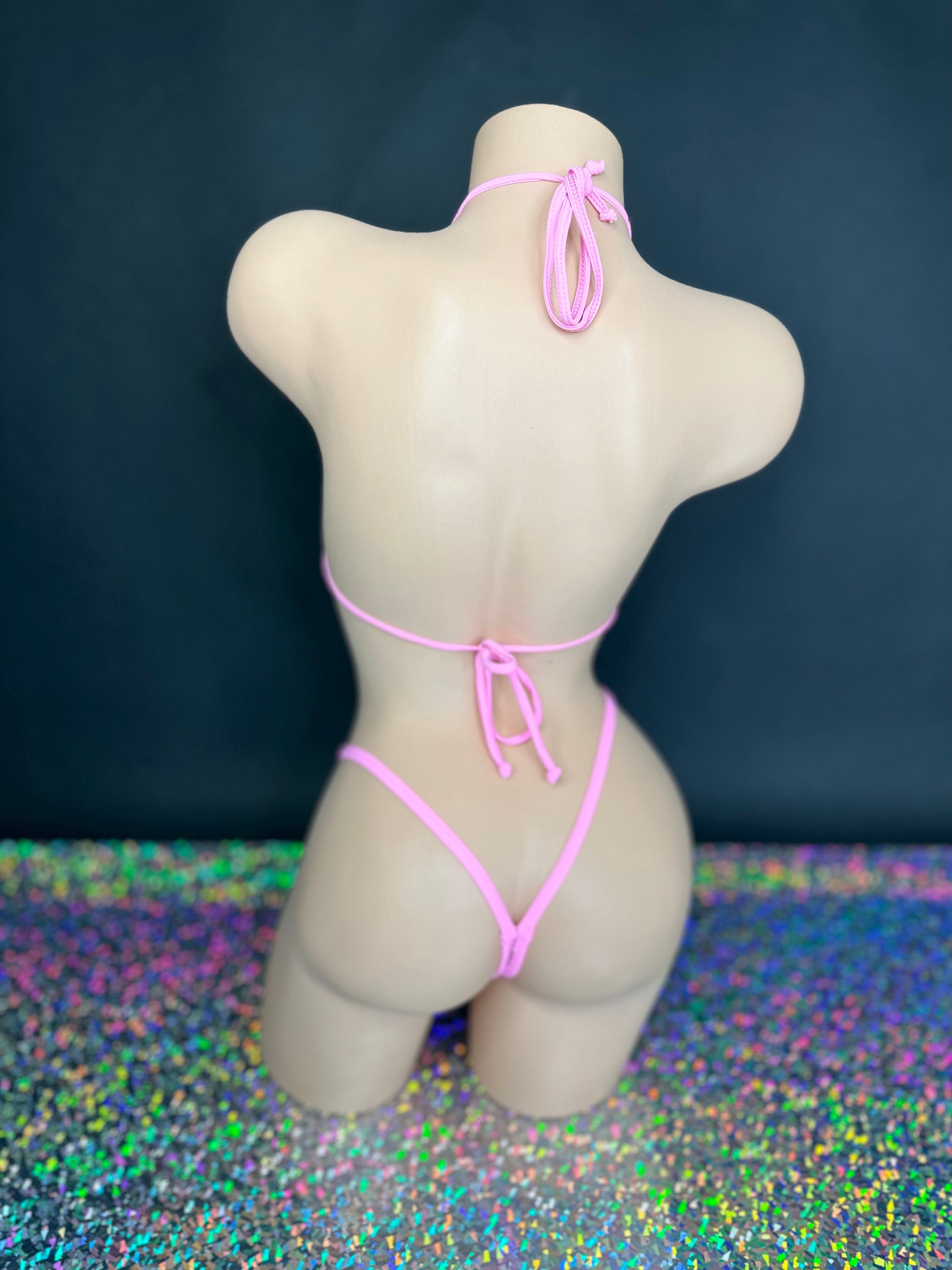 Bubble gum pink Katie 'kini, back view of ties and g-string on dark background with holographic floor - Golddiggers Boutique