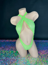 Lime green Ann rhinestone criss-cross bodysuit, front view on dark background with holographic floor - Golddiggers Boutique