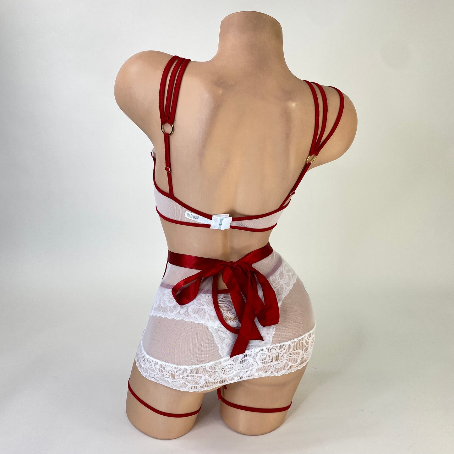 Naughty nurse costume peek-a-boo top detail with snap closure, close-up — Golddiggers Boutique exotic dancewear