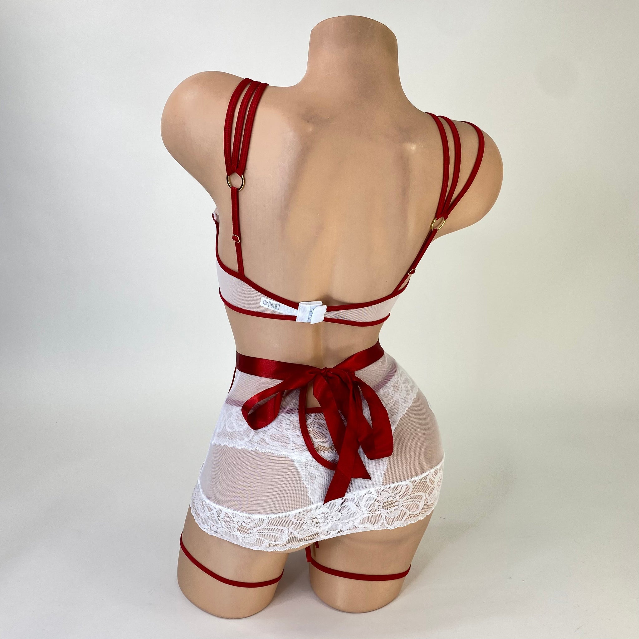 Naughty nurse costume peek-a-boo top detail with snap closure, close-up — Golddiggers Boutique exotic dancewear