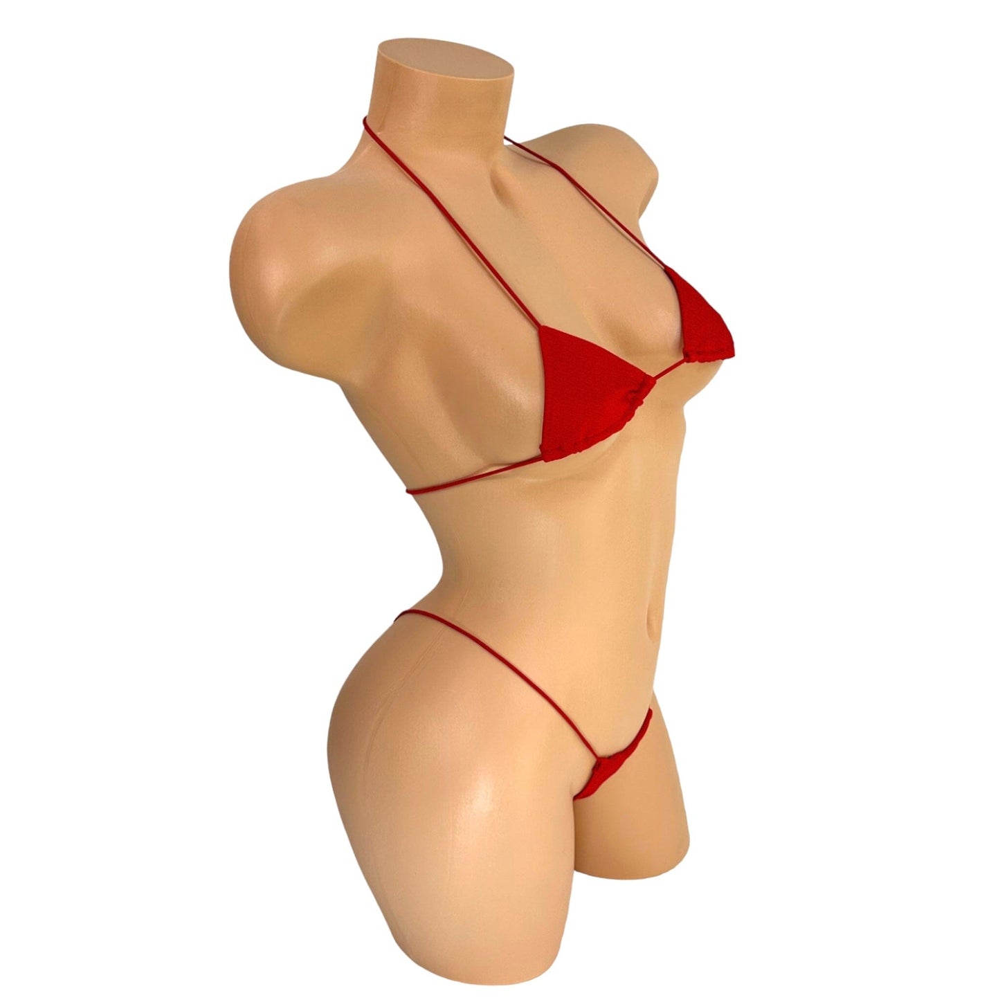 Red micro bikini set side view on mannequin showing minimal coverage — Golddiggers Boutique