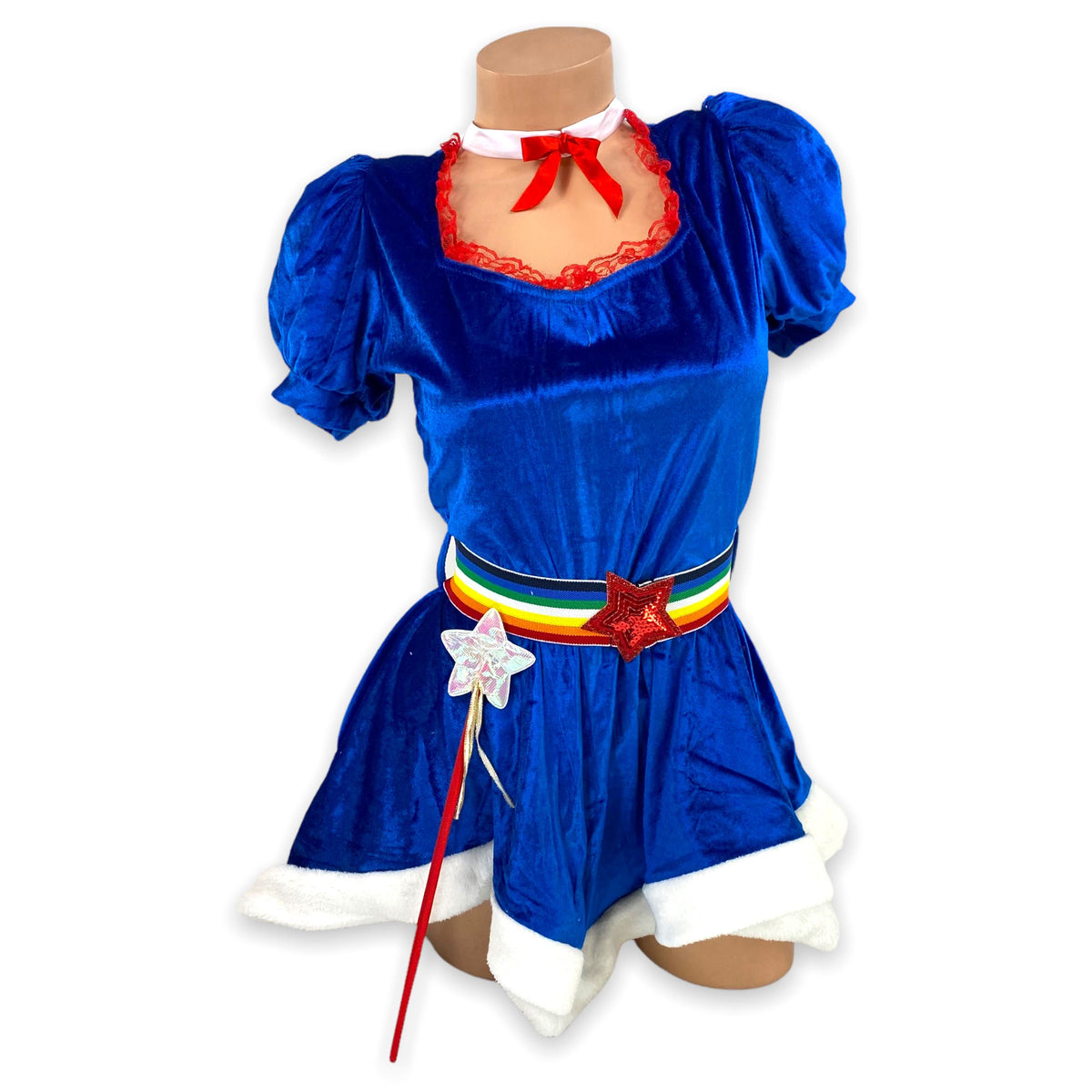 Royal blue velvet 80s rainbow girl costume with rainbow star belt, red bow, white fur trim, and star wand, front view