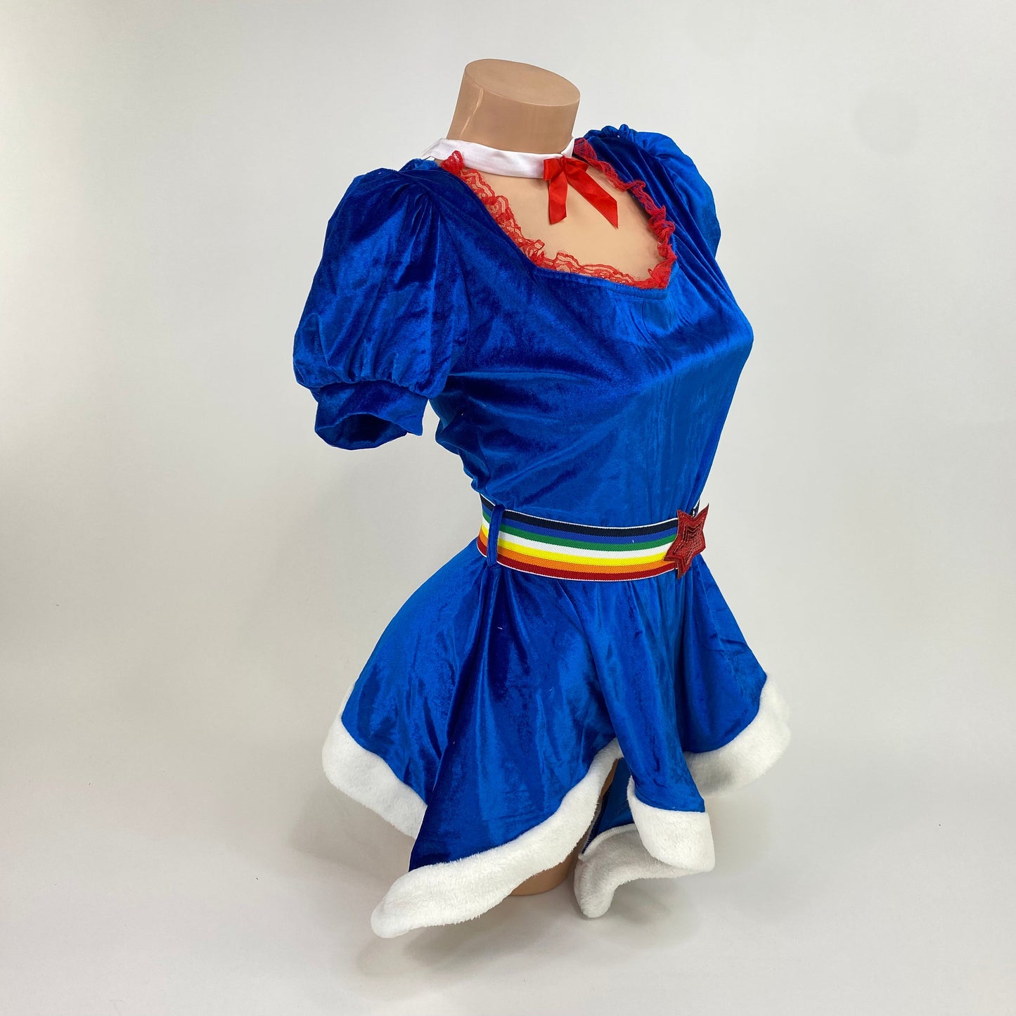 Side view of the royal blue velvet rainbow girl costume with red lace neckline and red sequin star belt